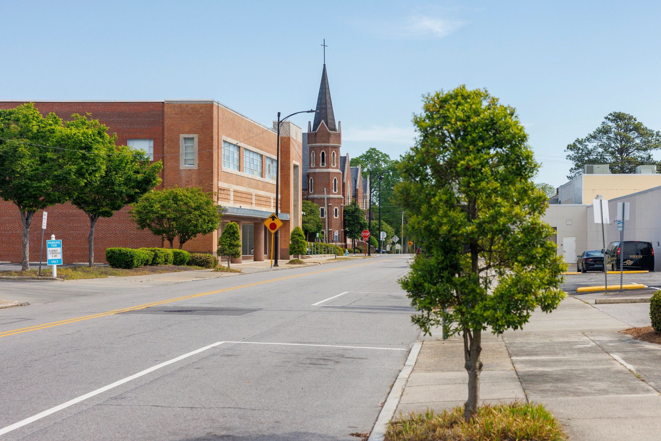 Church steeple rising above a downtown street